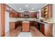 Spacious kitchen featuring rich wood cabinets, granite countertops, and a kitchen island at 1011 Buckhorn Bnd, Locust Grove, GA 30248