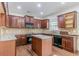 Well-lit kitchen with granite countertops, wood cabinets, and an island at 1011 Buckhorn Bnd, Locust Grove, GA 30248