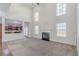 Spacious living room featuring a fireplace, large windows, and an open view to the kitchen at 1011 Buckhorn Bnd, Locust Grove, GA 30248