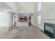 A spacious living room featuring a fireplace, an open floor plan, and an adjacent kitchen at 1011 Buckhorn Bnd, Locust Grove, GA 30248