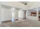 An open-concept living room with hardwood floors, neutral walls, and open kitchen access at 1011 Buckhorn Bnd, Locust Grove, GA 30248