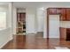 View of unfinished renovation between rooms with hardwood flooring, white doors, and neutral walls at 1011 Buckhorn Bnd, Locust Grove, GA 30248