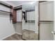 A walk-in closet features built-in shelves, mirrors, and carpeting at 1011 Buckhorn Bnd, Locust Grove, GA 30248