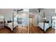 Primary bedroom with hardwood floors, a four-poster bed, and french doors leading to the outside at 1575 Montreat Pl, Atlanta, GA 30311