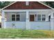 Charming home featuring a covered front porch, white brick foundation, and updated windows at 1575 Montreat Pl, Atlanta, GA 30311
