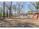 Expansive backyard featuring mature trees and patio at 3119 Bellgreen Way, Decatur, GA 30032