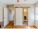 Bedroom with hardwood floors, sliding barn door, and ensuite bathroom at 3119 Bellgreen Way, Decatur, GA 30032