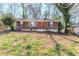 Charming single-story brick home with a red front door and well-maintained landscaping at 3119 Bellgreen Way, Decatur, GA 30032
