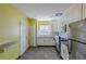 Bright kitchen featuring white cabinets, gray tile floors, stainless steel appliances and yellow walls at 3119 Bellgreen Way, Decatur, GA 30032