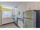 Bright kitchen featuring white cabinets, gray tile floors, stainless steel appliances and yellow walls at 3119 Bellgreen Way, Decatur, GA 30032