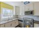 Bright kitchen featuring white cabinets, gray tile floors, stainless steel appliances and yellow walls at 3119 Bellgreen Way, Decatur, GA 30032