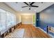 Open living room with hardwood floors, blue accent wall, a ceiling fan and natural light at 3119 Bellgreen Way, Decatur, GA 30032