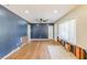 Open living room with hardwood floors, blue accent wall, a ceiling fan and natural light at 3119 Bellgreen Way, Decatur, GA 30032