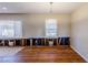 Spacious living room with hardwood floors, two windows and a chandelier light fixture at 3119 Bellgreen Way, Decatur, GA 30032