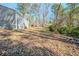 Expansive backyard with mature trees and side view of siding on home at 3524 Exeter Ct, Snellville, GA 30039