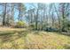 Large backyard with mature trees and grass at 3524 Exeter Ct, Snellville, GA 30039
