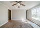 Inviting bedroom featuring a ceiling fan, neutral tones, and carpeted flooring at 3524 Exeter Ct, Snellville, GA 30039