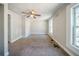 Bedroom featuring a window with a view, fan, and carpet providing a comfortable space at 3524 Exeter Ct, Snellville, GA 30039