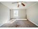 Inviting bedroom featuring a ceiling fan, neutral tones, and natural light at 3524 Exeter Ct, Snellville, GA 30039