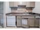 Functional kitchen with tiled backsplash, essential appliances, and wooden cabinetry at 3524 Exeter Ct, Snellville, GA 30039
