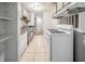 Functional kitchen featuring essential appliances, tiled flooring, and ample shelving at 3524 Exeter Ct, Snellville, GA 30039