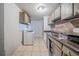 Functional kitchen featuring essential appliances, tiled flooring, and ample countertop space at 3524 Exeter Ct, Snellville, GA 30039