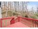 Red back deck surrounded by a wooded yard at 4041 Blanton Sw Ave, Atlanta, GA 30331