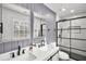 Bathroom with double sinks, updated countertops, framed mirrors, and a glass shower at 4041 Blanton Sw Ave, Atlanta, GA 30331