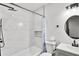 Bathroom featuring white tile shower with shampoo niche, matte black fixtures, and modern vanity at 4041 Blanton Sw Ave, Atlanta, GA 30331