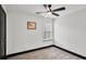 Spare bedroom featuring carpet, a large window, and a view of the neutral walls and black trim at 4041 Blanton Sw Ave, Atlanta, GA 30331