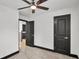 Bedroom with two black doors, ceiling fan, and neutral walls with black trim at 4041 Blanton Sw Ave, Atlanta, GA 30331