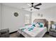 Neutral bedroom with ceiling fan, bright window, side tables and floral accents at 4041 Blanton Sw Ave, Atlanta, GA 30331