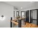 Upstairs hallway with hardwood floors, wood and black iron railing, and black doors with an open view at 4041 Blanton Sw Ave, Atlanta, GA 30331