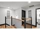 Second story hallway featuring black iron railing and black door frames at 4041 Blanton Sw Ave, Atlanta, GA 30331