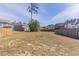 Spacious backyard with wood fence and view of neighborhood houses at 7434 Rudder Cir, Fairburn, GA 30213