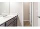 Bathroom featuring a dark-stained vanity, and a view into an adjacent room, creating a stylish and functional area at 7434 Rudder Cir, Fairburn, GA 30213