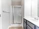 Bathroom featuring a shower with glass doors, a modern sink, and vanity, providing a clean and functional space at 7434 Rudder Cir, Fairburn, GA 30213