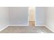 Clean bedroom with plush carpet and neutral walls and view of the closet space at 7434 Rudder Cir, Fairburn, GA 30213