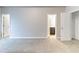 A carpeted bedroom featuring three doorways, each leading to different areas of the house at 7434 Rudder Cir, Fairburn, GA 30213