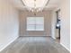 Bright dining room featuring neutral walls, carpeted floor, and modern chandelier at 7434 Rudder Cir, Fairburn, GA 30213