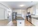 Open-concept kitchen with island, stainless steel appliances, and access to living spaces at 7434 Rudder Cir, Fairburn, GA 30213