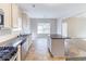 Open kitchen with granite countertops, stainless steel appliances, and an island at 7434 Rudder Cir, Fairburn, GA 30213