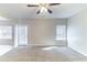 Bright and airy living room with a ceiling fan, carpeted flooring and natural light at 7434 Rudder Cir, Fairburn, GA 30213