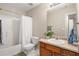 Well-lit bathroom with shower/tub combo and a vanity with a faux plant at 805 Pleasant Hill Rd # 171, Lilburn, GA 30047