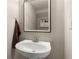 Modern bathroom with a pedestal sink, framed mirror, and a neutral color scheme at 805 Pleasant Hill Rd # 171, Lilburn, GA 30047