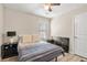 Cozy bedroom features a ceiling fan, bedside table, and neutral decor at 805 Pleasant Hill Rd # 171, Lilburn, GA 30047