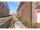 Brick townhomes featuring manicured bushes and a sidewalk leading to the entrances at 805 Pleasant Hill Rd # 171, Lilburn, GA 30047