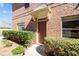 Charming brick townhome entrance with a covered doorway and well-maintained landscaping at 805 Pleasant Hill Rd # 171, Lilburn, GA 30047