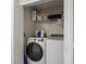 Laundry room with washer, dryer and wire shelving at 805 Pleasant Hill Rd # 171, Lilburn, GA 30047