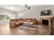 Cozy living room with a fireplace, ceiling fan, and a large sectional sofa at 805 Pleasant Hill Rd # 171, Lilburn, GA 30047